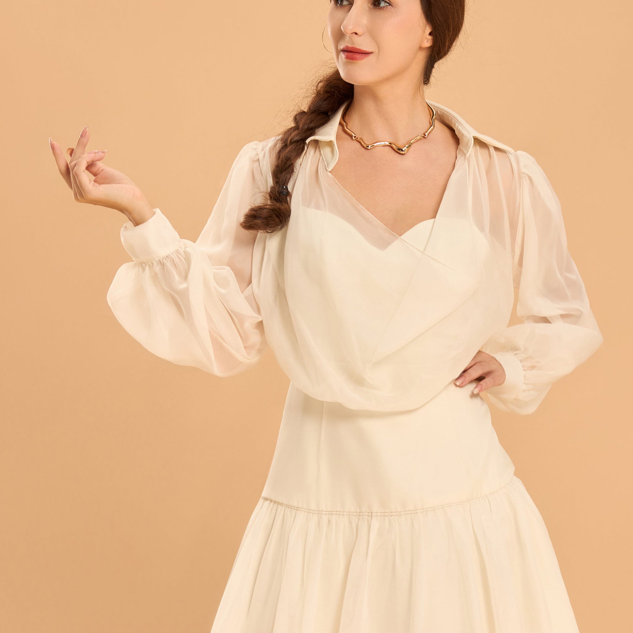 Model wearing a luxurious white-color long-sleeve chiffon dress with collar and a-line skirt from Vanda Modes
