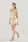 Woman wearing a light yellow Aria Hand-Smocked 100% washed premium Linen top and shorts from VandaMod on a white background