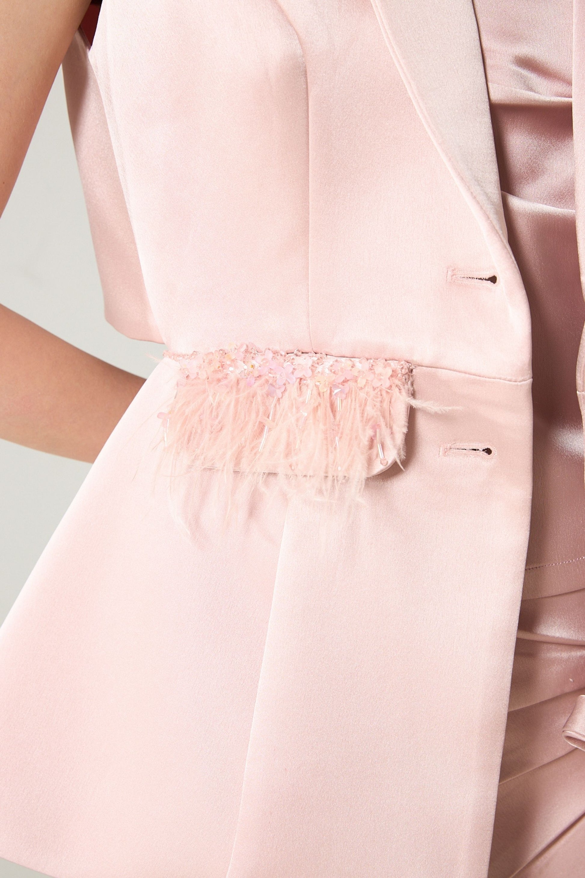 She is wearing Aurelia Open-Back Feather Blazer at VandaMod