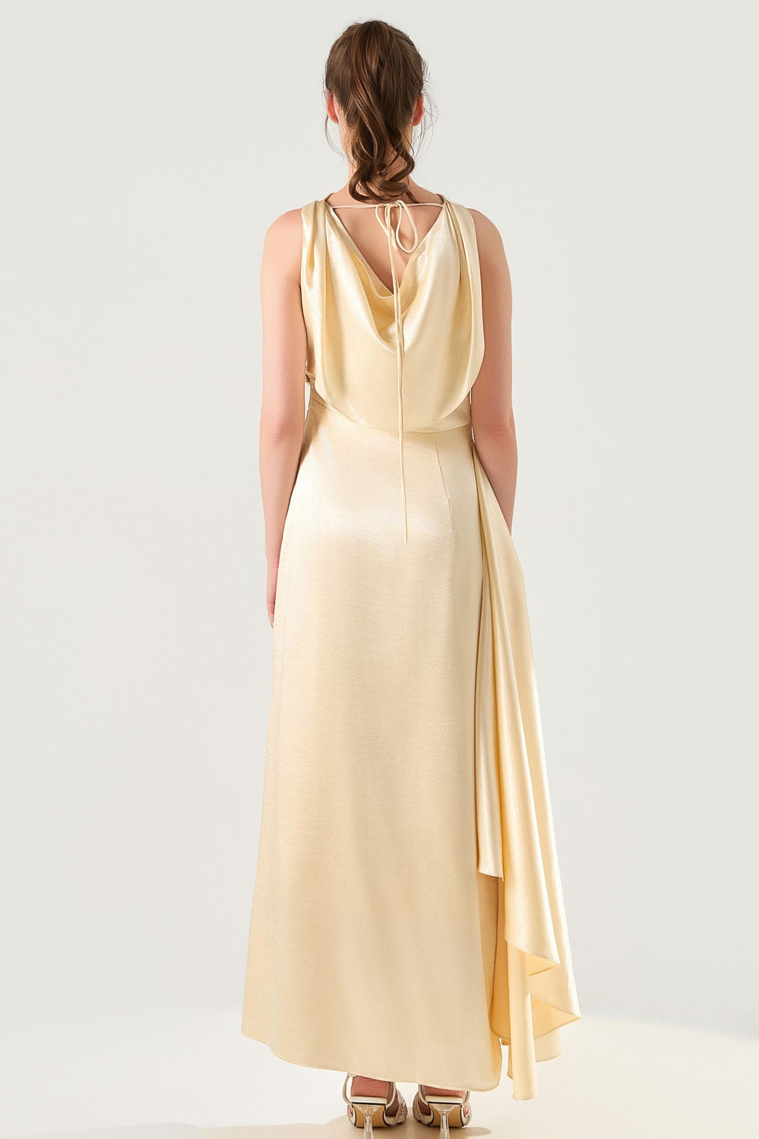 She is wearing  Celeste Champagne Polysilk Dress at VandaMod