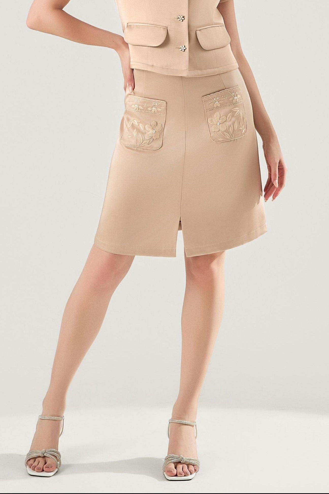 She is wearing Clara Embroidered Polysilk Skirt at VandaMod