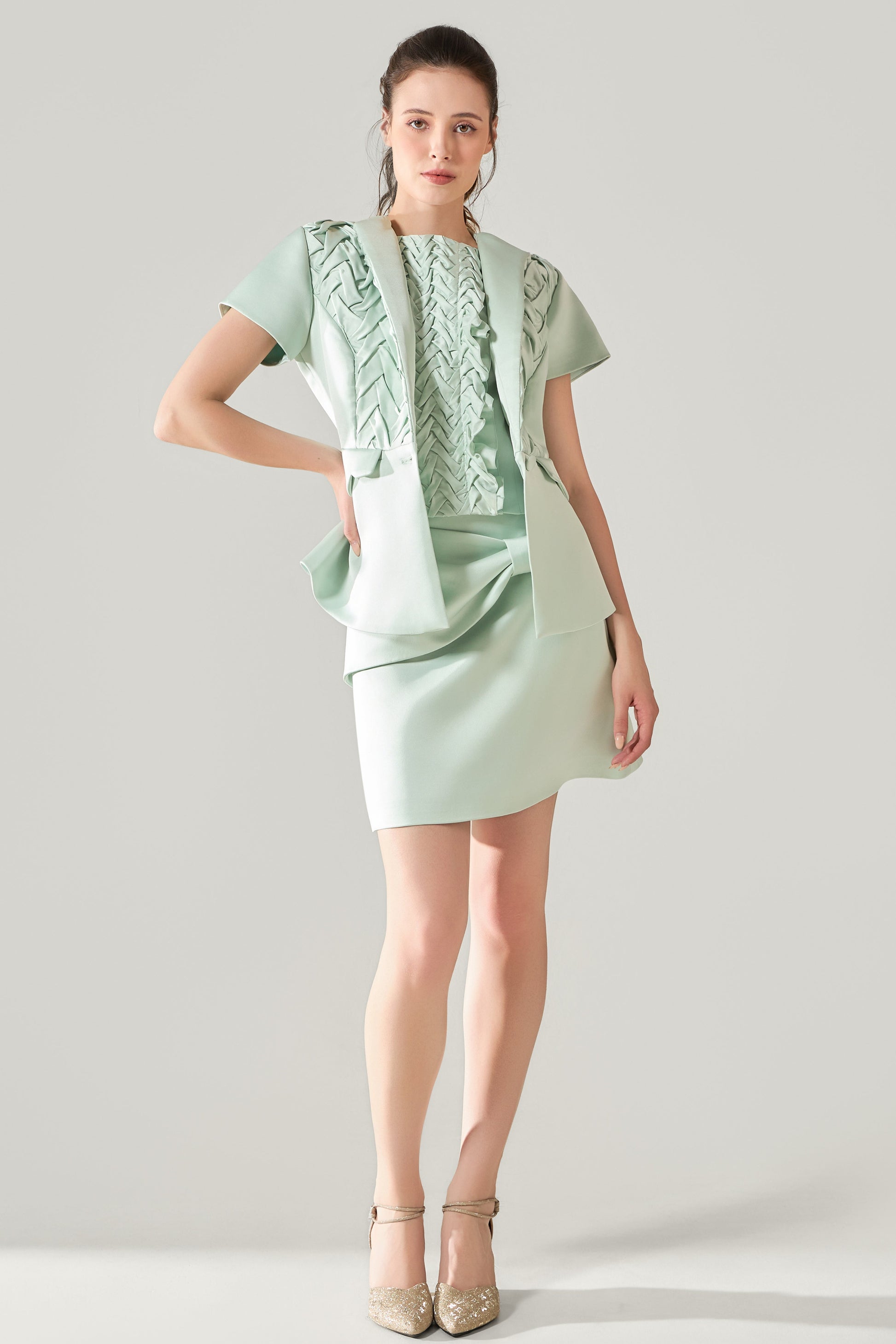 She is wearing Elara Hand-Smocked Polysilk Blazer at VandaMod