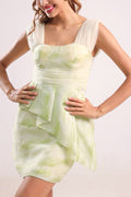 Woman wearing a light green dress with a subtle pattern on a plain background from vandamod designer fashion singapore