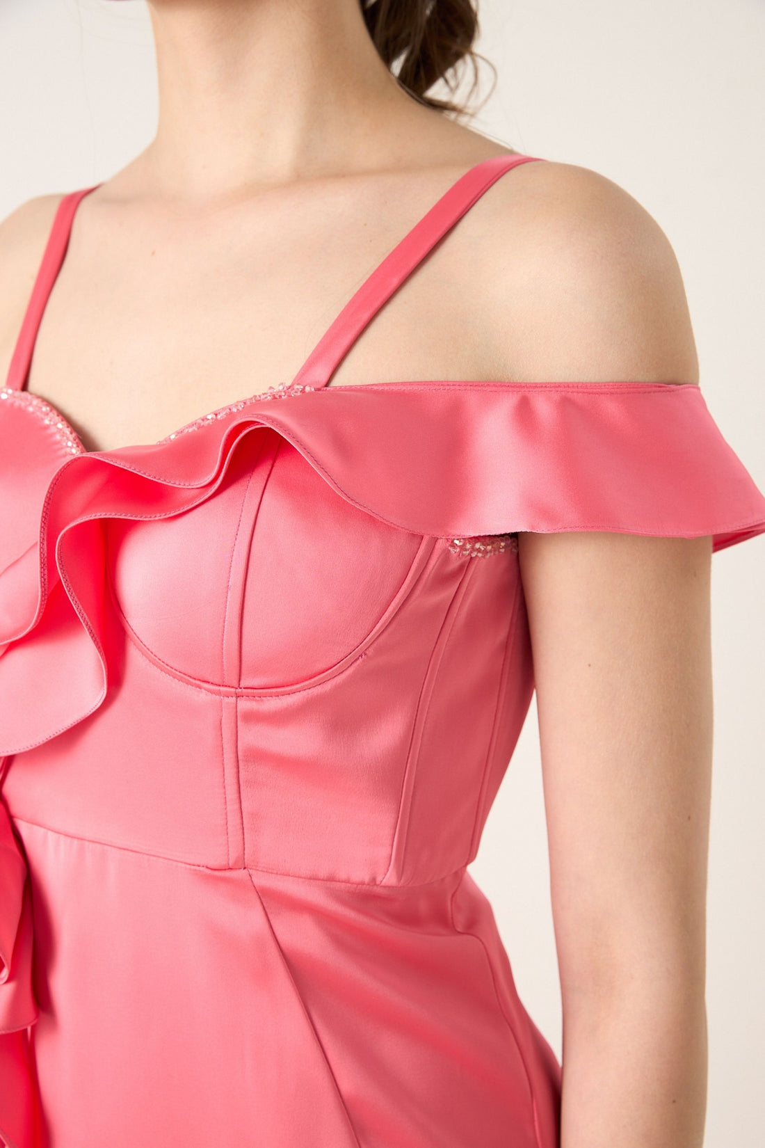 Woman wearing a pink dress with floral details