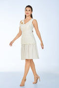 Woman wearing a white dress with smocking details on a light blue background from vandamod designer fashion sg